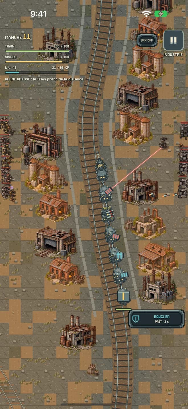 Le train progresse au milieu des bâtiments industriels.